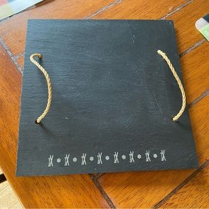 Slate cheese plate engraved with skis and delicate snowflakes. Two ropes handle